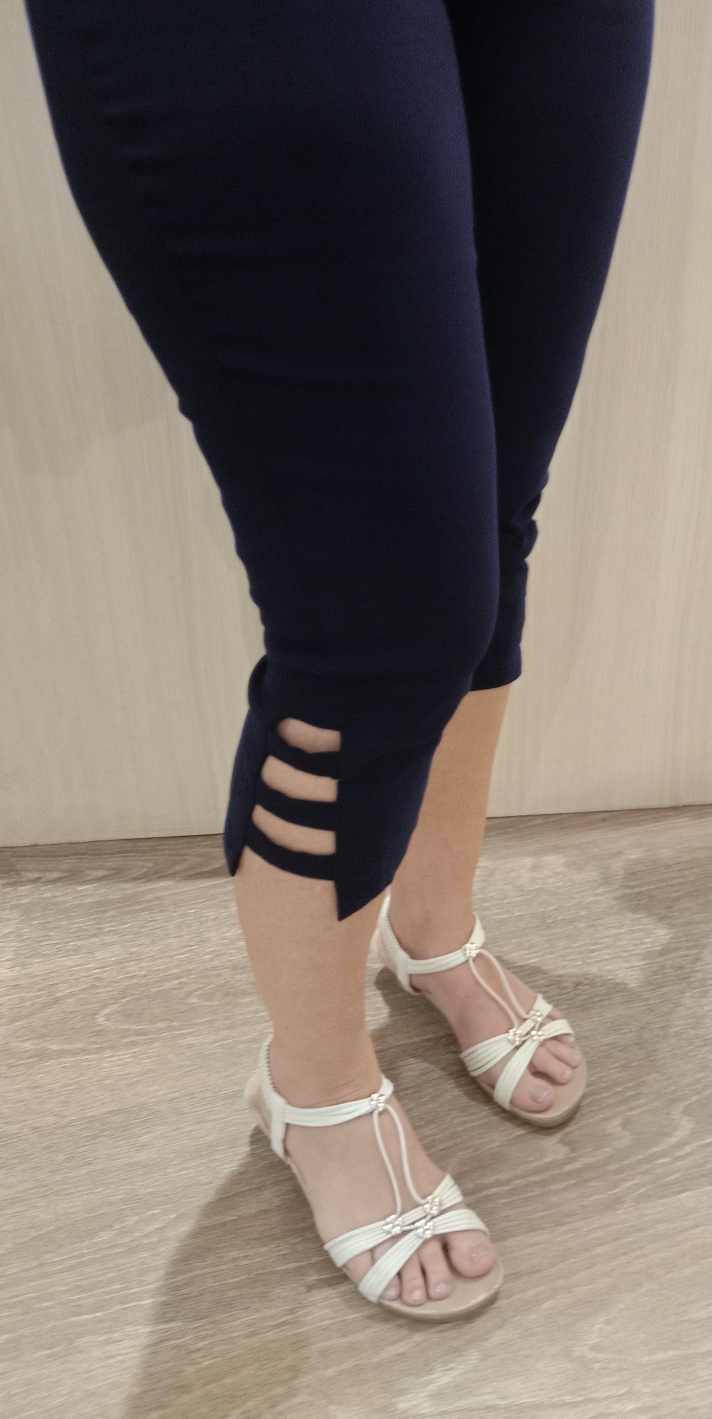 Woman wearing navy SSF Stripe Pants with white sandals near Boo Boo's counter